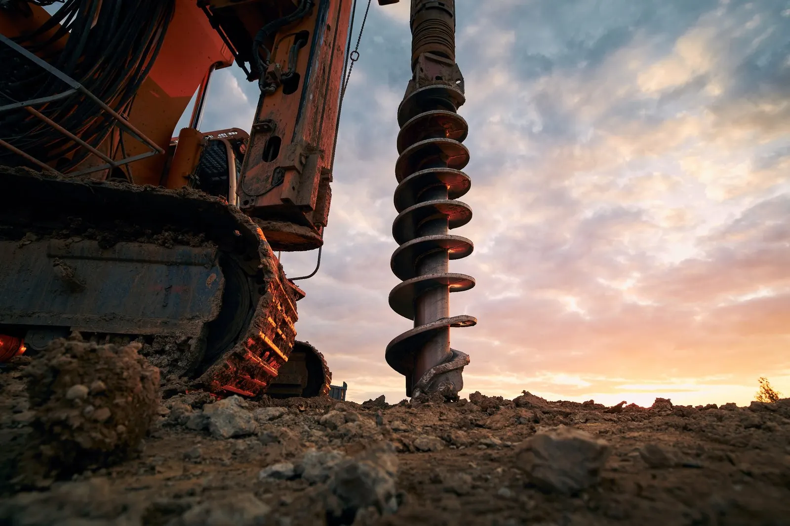 Background showing ground screw installation process