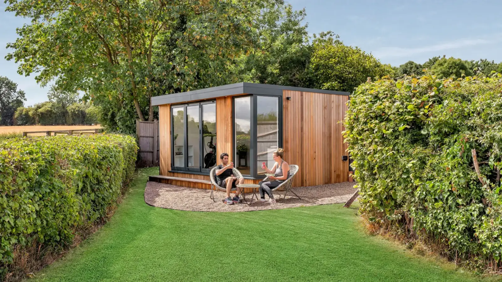 A finished insulated SIP garden room installed on a ground screw foundation in a landscaped garden